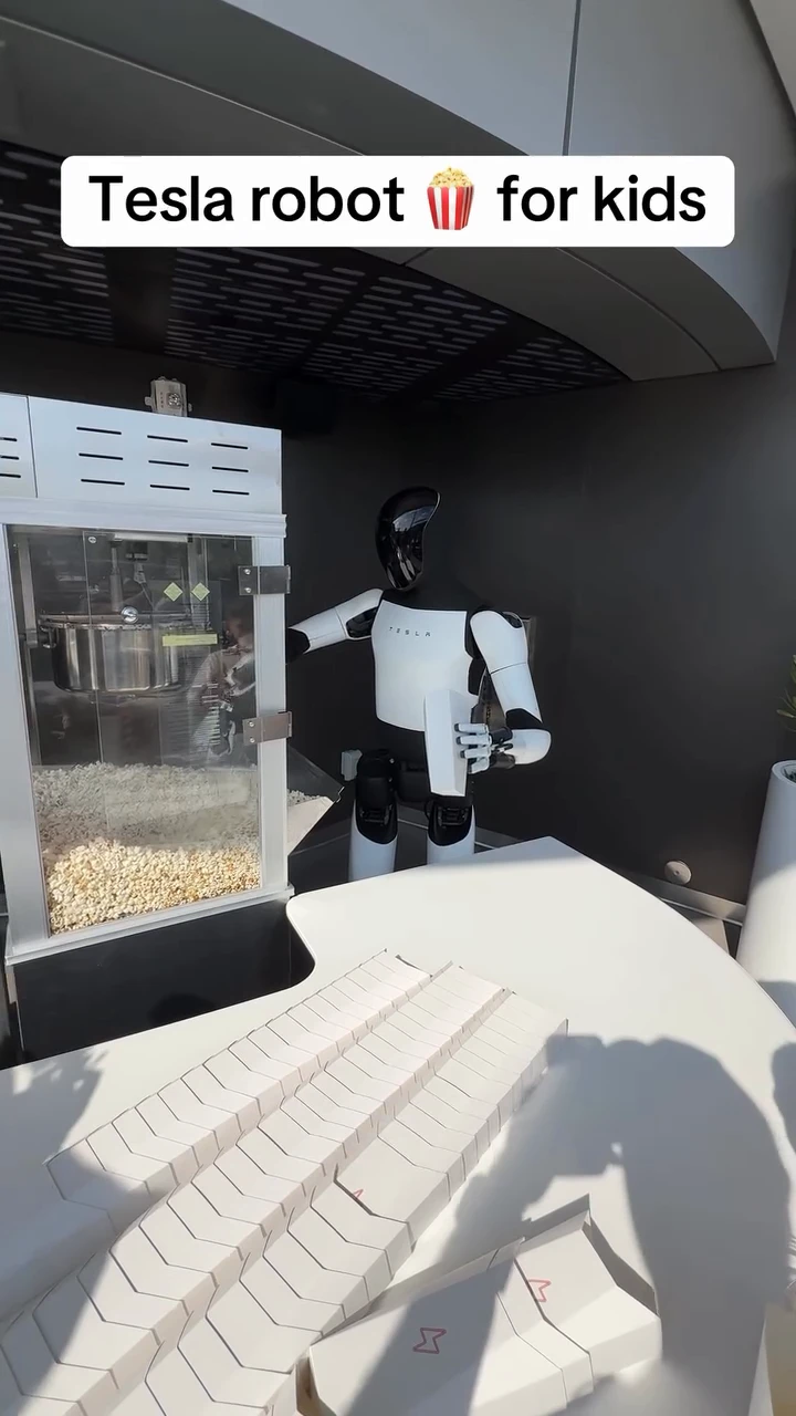 Tesla Robot Optimus feeds popcorn to children