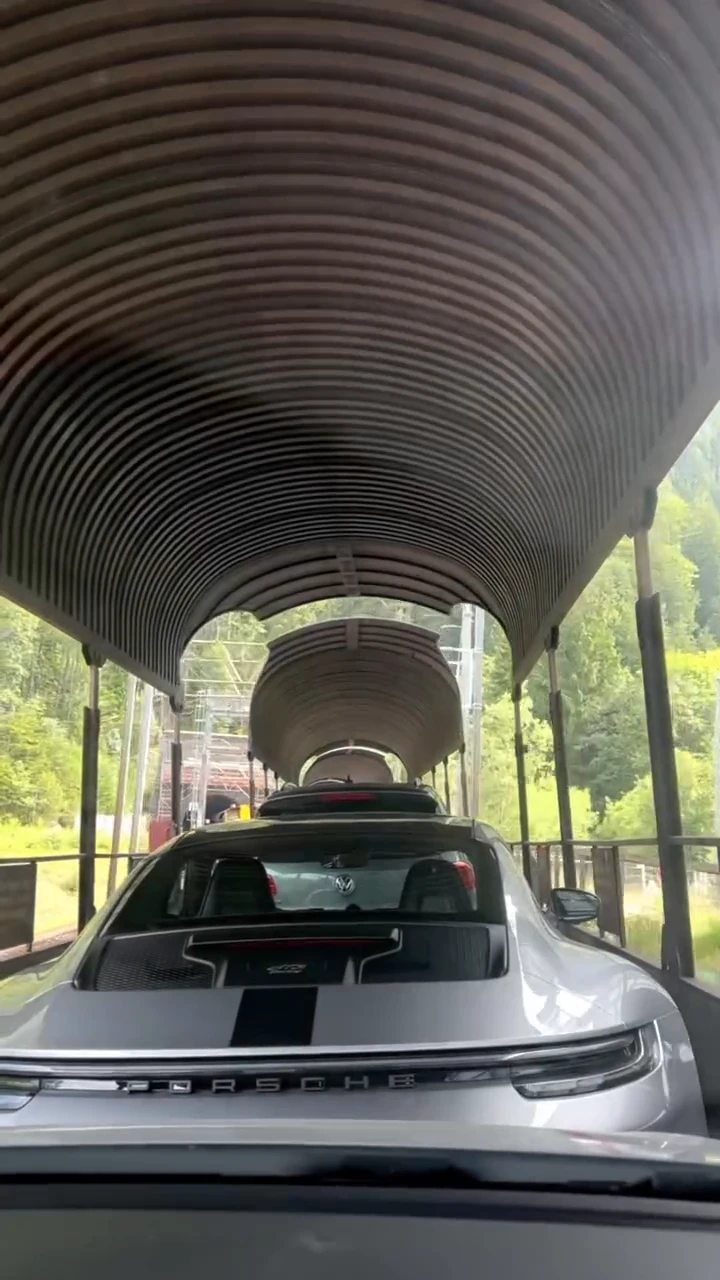 Unique road in Switzerland with a road crossing by railroad tracks